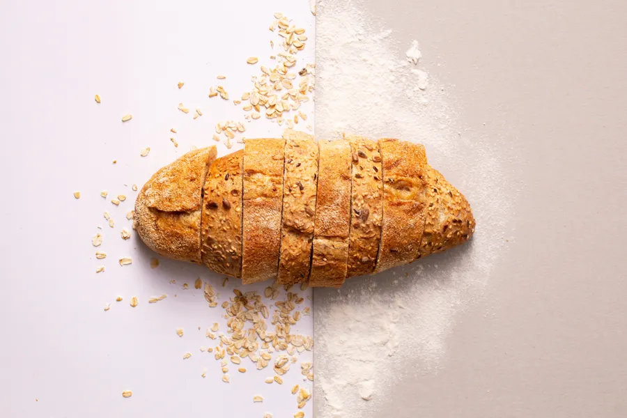 A crusty seeded Italian loaf, freshly sliced