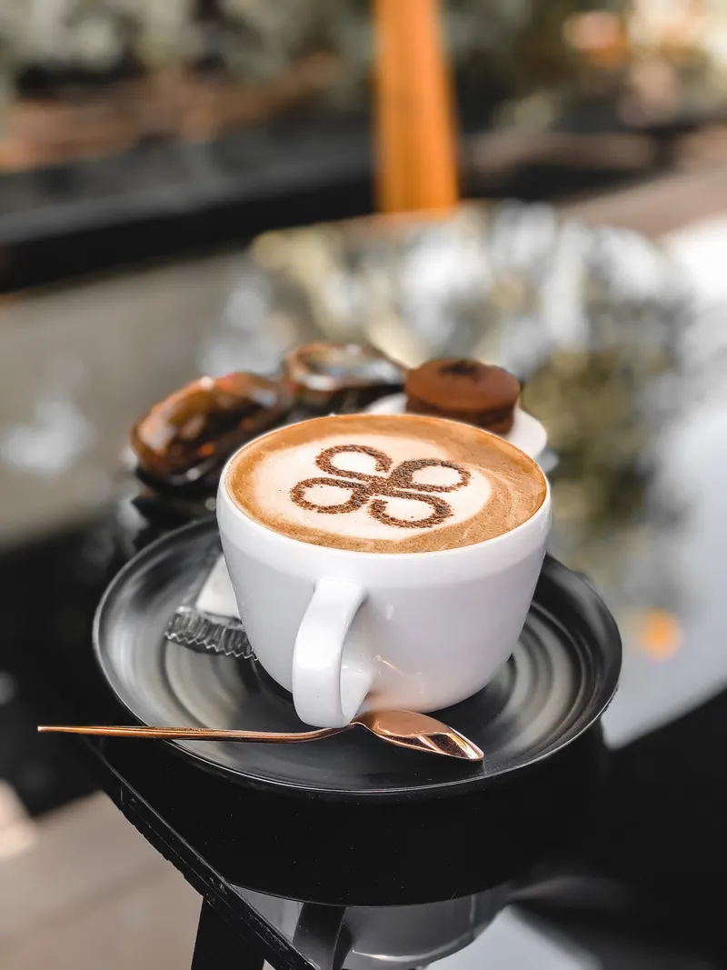 A cappuccino with dusted cocoa on a saucer