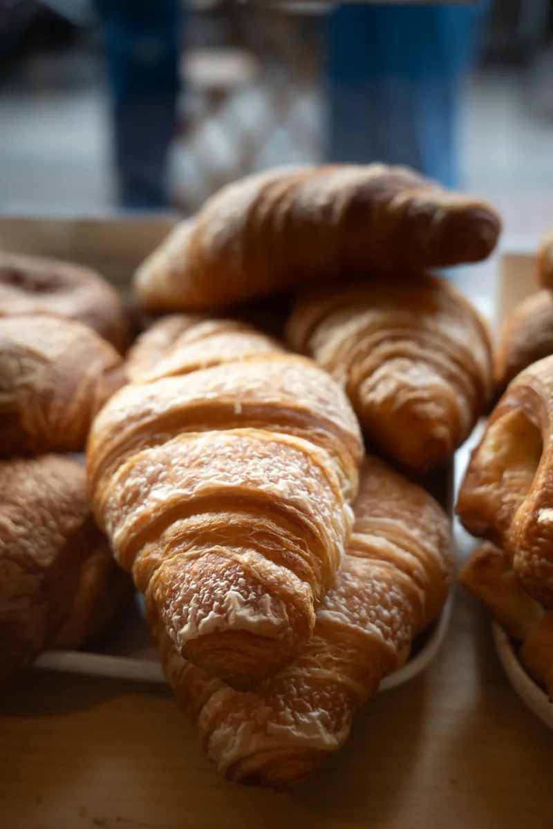 Golden butter cornetti and pastries on the counter